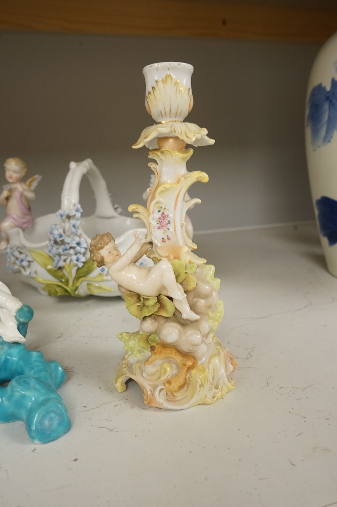 A pair of Sitzendorf figurines, damage to one, a pair of candlesticks, a Rye pottery dish, a Moore Bros. wall pocket, a doll and a basket, tallest 22.5cm